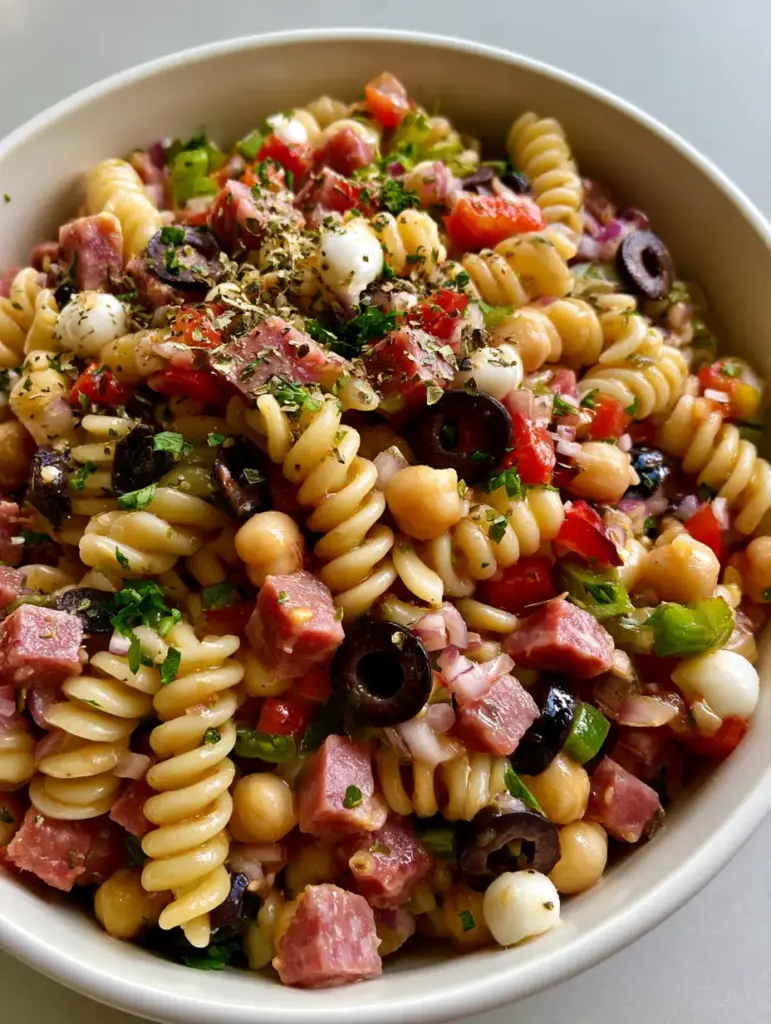 High-angle close-up of High-Protein Italian Pasta Salad featuring rotini, chickpeas, and vibrant bell peppers.