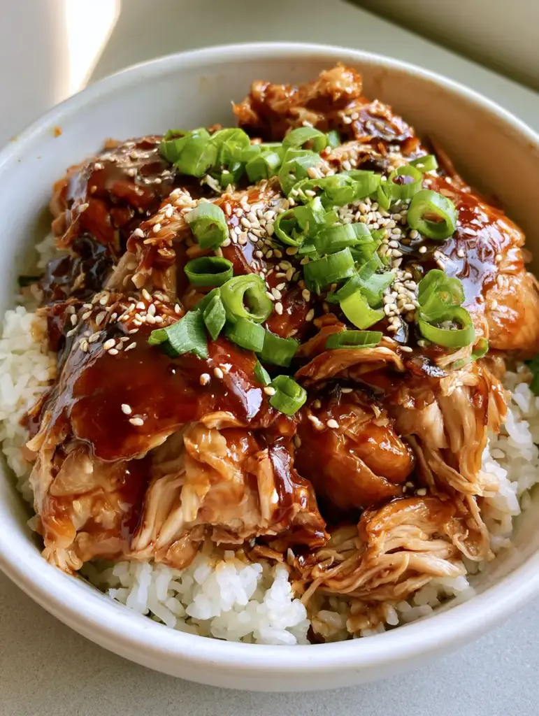 A wide shot of slow cooker chicken thighs served in a white ceramic bowl on a gray surface with soft natural lighting.
